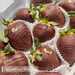 I believe in simple, pure indulgence. Here, perfectly ripe, succulent strawberries are hand-dipped in rich dark chocolate and finished with a delicate touch of 24-carat edible gold foil for a truly gourmet delight.