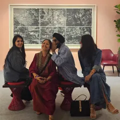 Our curated spaces are designed to be lived in, not just observed. Here, visitors relax and converse, demonstrating how we successfully create a comfortable and social atmosphere even within a formal gallery setting.