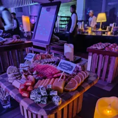 A beautifully arranged cheese and fruit board at the Mercedes EQ launch. This checkerboard-patterned board includes smoked English cheddar, fresh oranges, and various other cheeses, creating a visually stunning and delicious offering.