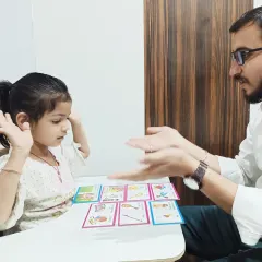 A language therapy session at our Gwalior center, where a child is learning through picture cards. This method helps in building vocabulary and associating words with images.
