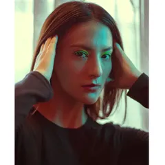 An experimental portrait using a mix of green and warm light. This technique creates a unique, futuristic mood perfect for an edgy portfolio.