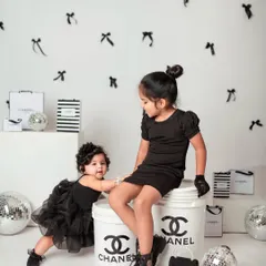 Showcasing a fun and creative themed shoot in the studio. These sisters are styled in black for a chic, high-fashion look with custom props.