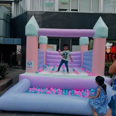 We love the soft, happy colors of our pastel bouncy castle. It comes with an attached ball pit filled with pink and blue balls, making it a beautiful and fun centerpiece for any celebration, indoors or outdoors.