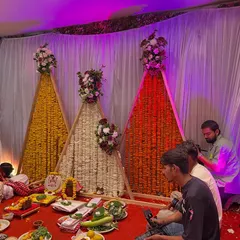 A unique and modern backdrop for a pooja ceremony. I used A-frame structures decorated with strings of marigold and rajnigandha flowers, with fresh floral bouquets on top.