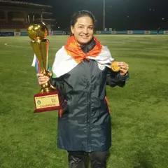 Our founder's journey is one of passion and achievement. Here she is, holding a championship trophy and medal, a testament to the high level of experience she brings to our coaching philosophy.