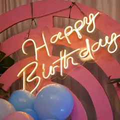 Another look at our bright and stylish 'Happy Birthday' neon sign, set against a colorful pink backdrop. It's a simple but effective way to elevate party decor.