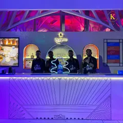 Our professional team posing behind the stylish, custom-built Don Julio bar. Their sharp uniforms and confident presence ensure that the service is as high-quality as the setup.