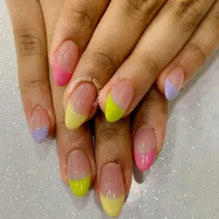 Pastel dreams. We created this soft, multi-color look using a different pastel shade for each French tip, including yellow, pink, and lavender, for a subtle yet playful manicure.