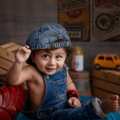 This little mechanic is ready for business! Themed toddler photoshoots are a fantastic way to showcase your child's budding personality. I provide all the props, from the denim cap and overalls to the vintage garage signs.