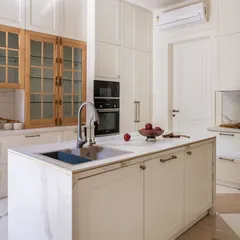 A well-appointed kitchen is the heart of the home, and its details matter. In this stunning residence, our Sphere cabinet pulls and Cremone bolts in an Antique Brass matte finish provide a warm, metallic counterpoint to the clean white cabinetry and natural wood. It is a testament to how the right hardware can elevate a space from functional to exceptional.