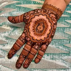 This mandala design is a perfect example of negative space filling. The central floral pattern is highlighted by the dark, filled-in space around it, making the details stand out.