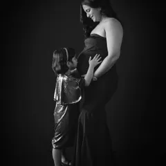 A touching black and white moment between a mother and her daughter, both excited to meet the new baby.