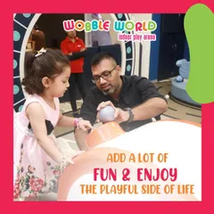 A father and daughter share a playful moment. We love providing a space where families can connect and enjoy quality time together.