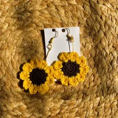 These crochet sunflower earrings are perfect for adding a pop of sunshine to your look. They are meticulously handcrafted to capture the cheerful look of a real sunflower.