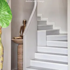 The bronze Pratima sits on a custom-designed travertine console from my Matilda collection. We used focused lighting to highlight the statue and create a serene focal point.