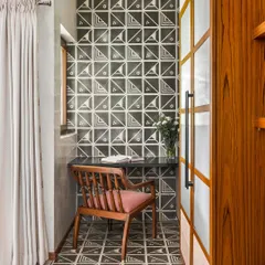 Even a small alcove can become a beautiful, functional space. This compact study nook is defined by bold, patterned tiles and a simple wooden desk, proving that good design doesn't require a lot of room.