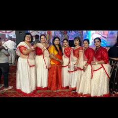 The final result of weeks of practice. This ladies' group is ready to perform their Garba routine, showcasing their coordinated costumes and polished dance moves.