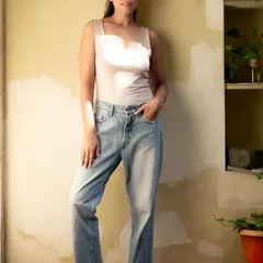 A full-length shot in a basic tank top and jeans, serving as a perfect modeling polaroid or a base for a casual styling campaign.