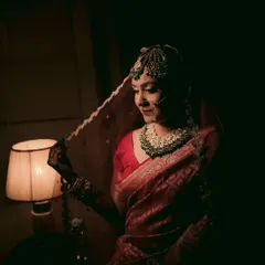 A classic bridal portrait using chiaroscuro lighting from a lampshade to create a dramatic, intimate, and timeless feel.