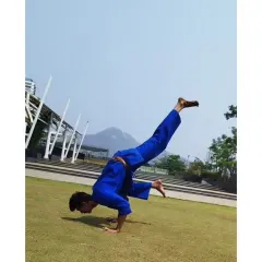 A variation of an arm-balance pose, demonstrating incredible control and flexibility. Our training incorporates yoga and gymnastics to enhance our karate skills.