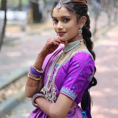 An outdoor bridal portrait where the bride is looking directly at the camera. Her confident pose and beautiful traditional attire make for a powerful shot.