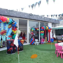 A full view of a superhero party setup in our outdoor area, combining themed decorations with play space.