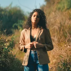 A quiet, contemplative moment during our outdoor shoot. The warm sunlight and natural surroundings create a peaceful and authentic mood.