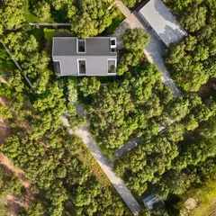 From above, the geometric layout of the house and its surrounding pathways becomes clear. The design is a thoughtful response to the site, creating a private residence that feels completely immersed in nature.