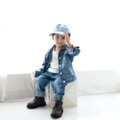 A stylish toddler posing in his denim-on-denim outfit. I love capturing the unique personality of every child.