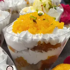 The Motichoor Laddoo Tres Leches combines two beloved desserts in one cup. A moist cake base is topped with whipped cream and a generous layer of fresh motichoor.