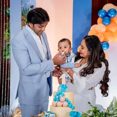 The first taste of cake is a special moment. We focus on capturing these key interactions, like the parents feeding their son his first birthday cake, creating a timeless memory for the family.