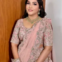 A beautiful and soft sagan makeup look. The focus is on flawless skin and rosy tones, which look stunning with her pastel pink embroidered lehenga.