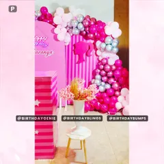 A detail shot of the Barbie party decor, focusing on the floral arrangement and the texture of the metallic and pearl-finish balloons.