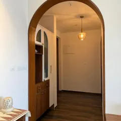 Arch update: still curving, still thriving. If soft entrances were a love language, this would be ours. A beautiful wooden archway creating a warm and welcoming passage.