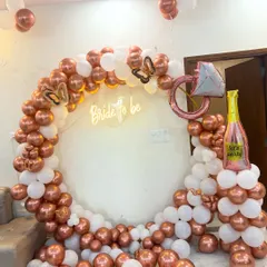This chic bridal shower decor is perfect for creating those Instagram-worthy moments. I used a popular rose gold and white color palette to build a full balloon arch, adding fun elements like a diamond ring and champagne bottle foil balloon, all centered around a 'Bride to be' neon sign.