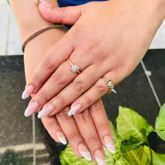 Here is a modern twist on the classic French tip, with clean white swirls on a natural nude base. This design is perfect for an everyday look that is still chic and eye-catching.