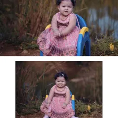A delightful outdoor baby portrait. The baby girl is sitting happily in a small chair by the water, dressed in a lovely pink dress, showcasing her cheerful personality.