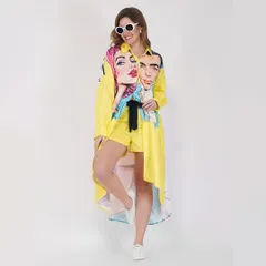 This model wears a bright yellow shirt dress with a pop art print, showcasing our ability to handle bold colors and unique designs in a studio setting.