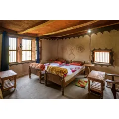 Another view of a homestay bedroom, built in collaboration with the local community. The entire process involved knowledge sharing, with elders guiding the construction and younger members providing the labor, resulting in a truly community-built space.