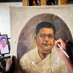 Here you can see my careful restoration process in action. I am meticulously retouching a portrait, using a reference photograph on my phone to ensure complete accuracy to the original artist's style.