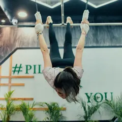This inverted pose on the Cadillac requires a high level of core control and upper body strength. It's a challenging move that we build up to with consistent training.