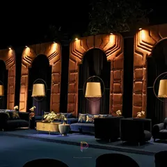 For this lounge area, we designed custom arched wall panels with a golden texture to evoke a sense of heritage architecture. Paired with modern pendant lamps and plush velvet seating, it became the perfect regal unwind zone.