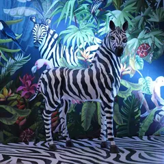 A head-on view of our zebra, standing proudly in his jungle home. Props like this are key to making a themed event feel truly transportive and memorable.