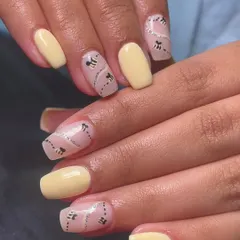 This honeybee-inspired nail art is so cute and chic. I used a pale yellow polish and created a negative space design with silver glitter trails and tiny, hand-painted bees.