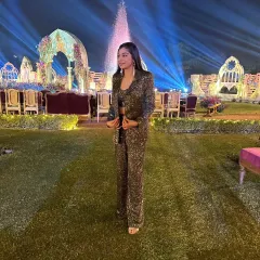 This olive green sequin co-ord set, featuring a blazer and matching flared pants, was designed for a destination wedding's welcome dinner. It's a glamorous and comfortable choice that makes a lasting first impression.