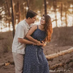 A playful and candid moment captured in the woods. The couple's easy laughter and embrace show their natural chemistry during their outdoor pre-wedding photoshoot.