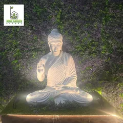 Creating a peaceful and positive vibe with a spotlit Buddha statue against a custom foliage wall. This is a powerful way to create a focal point.