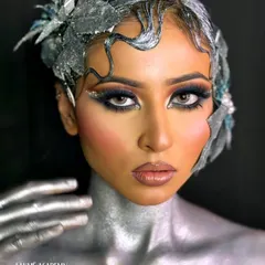 This metallic, avant-garde look is a testament to the skills taught in our advanced creative courses. Students learn to work with textures like glitter and metallic paints, along with creating custom headpieces.