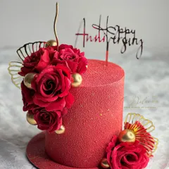 Roses are red, and this velvet-textured cake is a showstopper. The rich red color and floral decorations make it a perfect choice for a romantic anniversary celebration.