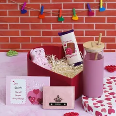 The "Love Keepsake Hamper" for her, featuring a personalized pink glass tumbler, a matching pink mini wallet, a teddy, chocolate, and a custom message card in a heart-shaped box.